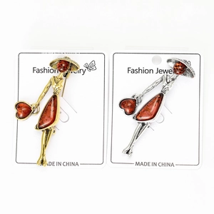 Detail of vintage lady brooches in gold and silver finish with amber resin inlays