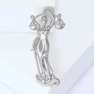 Macro shot of silver Lady Justice brooch featuring polished scale and sword details