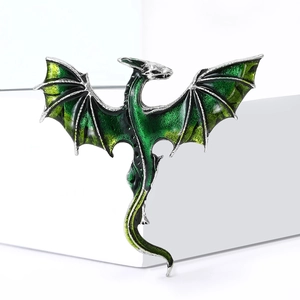 Exquisite fantasy dragon brooch with green enamel wings and silver alloy metal finish