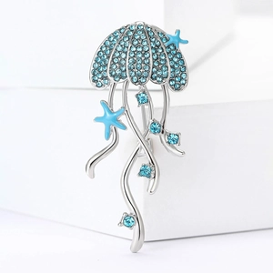 Exquisite silver jellyfish brooch with blue crystals and starfish accents on white blocks