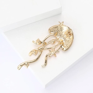 Detailed back view of gold jellyfish brooch showing the secure safety pin clasp mechanism