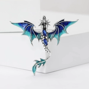 Vibrant blue enamel western dragon brooch with sapphire gems on a silver metal base