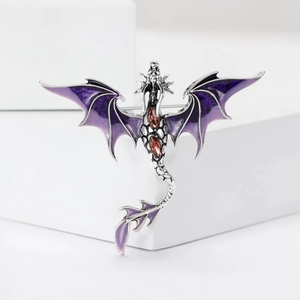 Detail showing high-end purple enamel dragon brooch with red gemstone on white blocks