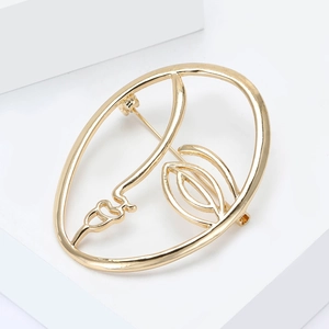 Artistic golden facial profile brooch with minimalist metal wire sculpture design details