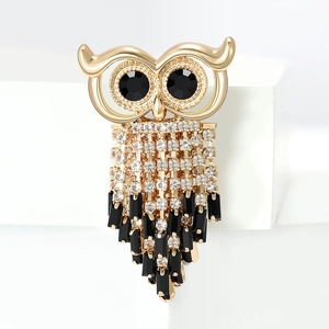 Fashionable owl brooch with golden metal tassels and sparkling crystal rhinestone inlay