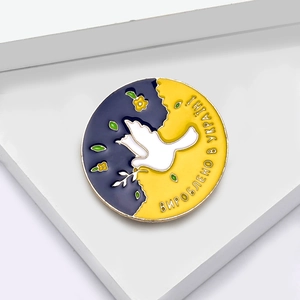 Vintage round enamel brooch with white peace dove and olive branch in blue and yellow