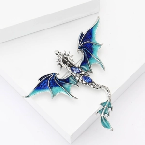 Detailed macro view of Western dragon brooch with blue enamel wings and crystal accents