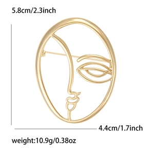 Minimalist gold face brooch with artistic lines and dimensions 5.8cm by 4.4cm