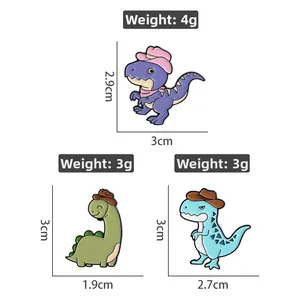 Detailed size specifications for three cute colorful dinosaur enamel pins wearing cowboy hats