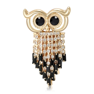 Vintage owl brooch with sparkling rhinestones and black gemstones in a gold-plated finish