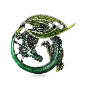 Green and black enamel dragon brooch in circular ouroboros shape on white background