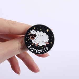 Close-up of a Space Sheep enamel pin featuring a white sheep in an astronaut helmet