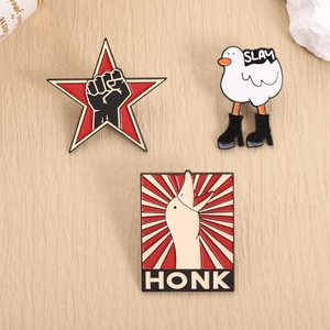 Funny enamel pins set featuring SLAY goose and star fist on beige textured fabric
