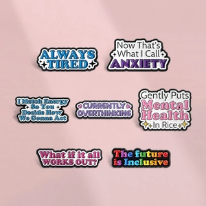 Set of seven colorful enamel pins featuring mental health quotes and starry graphics