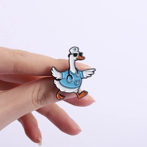 Detail of a cute doctor duck enamel pin with blue scrubs, sunglasses, and stethoscope badge