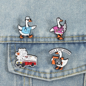 Set of four cute medical goose enamel pins featuring doctor and nurse designs on denim