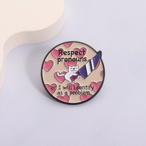 Detail of round enamel pin with cat holding dagger and respect pronouns text design