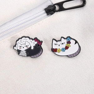 Funny fat cat enamel pins featuring wreath and ribbon designs on a white canvas bag
