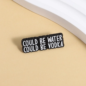 Macro detail of enamel pin with humor quote Could Be Water Could Be Vodka text
