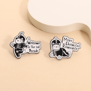 Detail of cat parade enamel pins with black and white cat conductor and cat logos