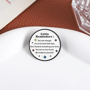 Creative enamel pin badge with motivational quotes and stars on a white background