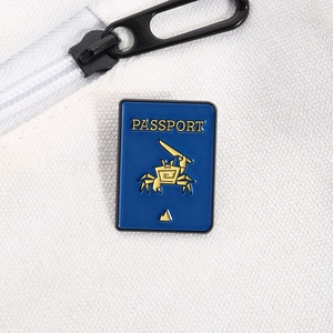Detailed close-up of blue enamel crab passport pin badge on canvas bag fabric