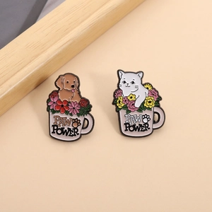 Detailed view of cute cat and dog enamel pins featuring Paw Power text in pink cups