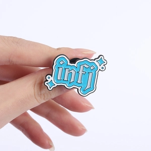Detailed close-up of INFJ enamel pin with cute light blue lettering and star accents