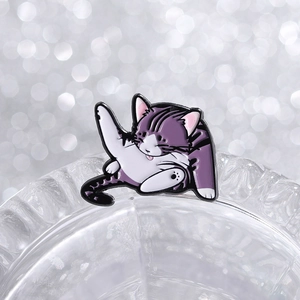 Detailed view of a purple striped cat enamel pin cleaning its fur on glass edge