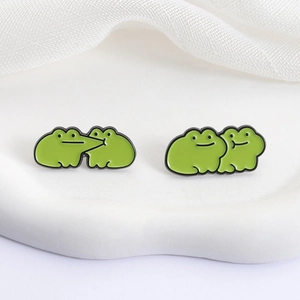 Cute green enamel frog pins set for couples featuring funny cartoon animal brooch designs