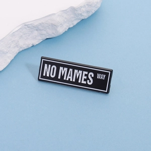 Funny enamel pin featuring NO MAMES WAY slogan on black background with blue display