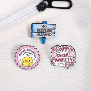 Three enamel pins for social anxiety on canvas background with text Social Gathering Survivor