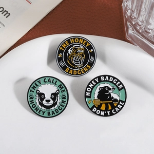 Three cute honey badger enamel pins set in round zinc alloy metal with gold finish and slogans