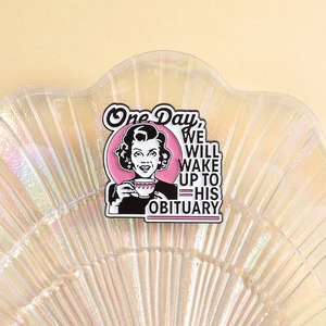 Detailed close-up of a vintage pop art enamel pin on a pearlescent shell tray