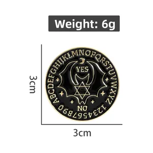 Macro shot of circular gothic bat enamel pin with Ouija board letters and YES/NO text