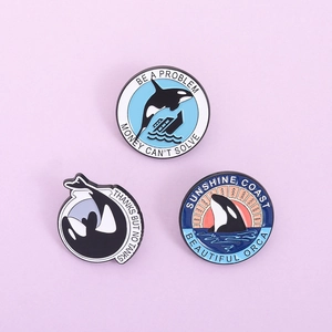 Three-piece set of cartoon orca enamel pins featuring creative killer whale ocean designs