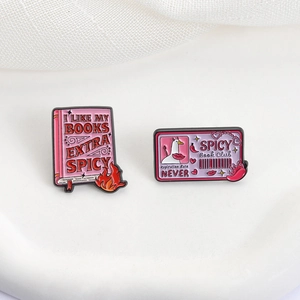 Pink spicy book club enamel pins set with artistic lettering on white background