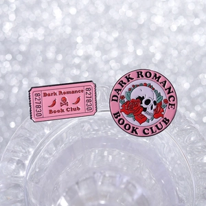 Detailed macro view of enamel pins featuring skull and roses Dark Romance Book Club design