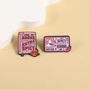 Enamel book badges with Spicy Book Club slogans and funny goose design on beige base