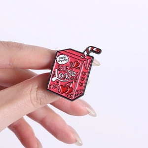 Detailed view of pink enamel self love juice box pin with heart and cherry details