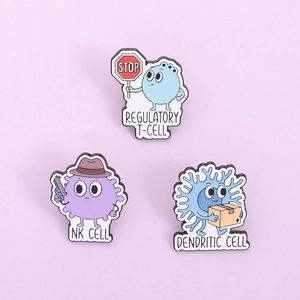 Close-up of T-cell and NK cell enamel pins with a soft purple background detail