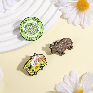 Three-piece vegan enamel pin set featuring animals and friends not food slogans