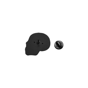 Macro view of matte black skull enamel pin back with durable rubber clutch fastener