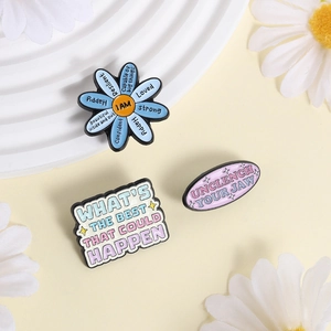 Tre spille in smalto con citazioni motivazionali e fiore blu per abbigliamento e accessori