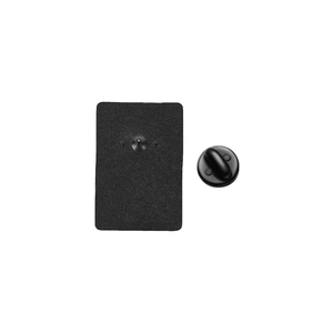 Detail view of the black metal brooch back with sandblasted texture and rubber clutch