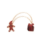 Détail de la broche chaîne bonhomme de pain d'épices et boîte cadeau de Noël dorée