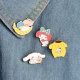 Detailed view of colorful Sanrio-style enamel pins on denim jacket showing creative design