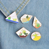 Detailed view of 5-piece geometric succulent pins pinned on blue denim fabric background