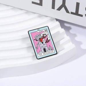 Colorful Tarot XVI enamel brooch featuring The Patriarchy tower design on white wavy stand