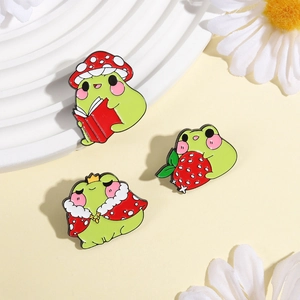 Three cute frog enamel pins with mushroom hat, strawberry and royal cape accessories